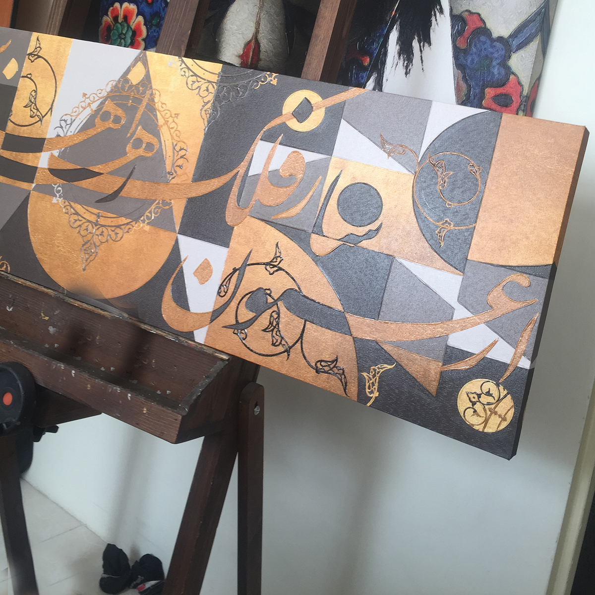 Panorama painting with golden calligraphy of Hafez Naghmeh's poem "The Feast of Geometry" from Chargoosh Gallery